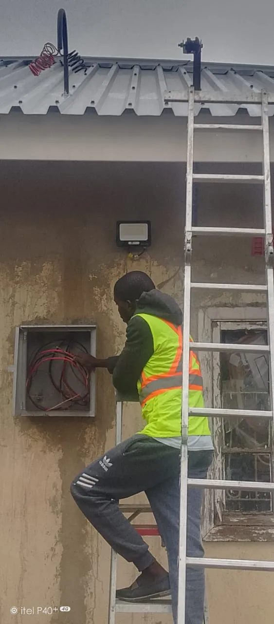Danford Electrical technician in hi-vis vest working on external electrical cable box in Gauteng