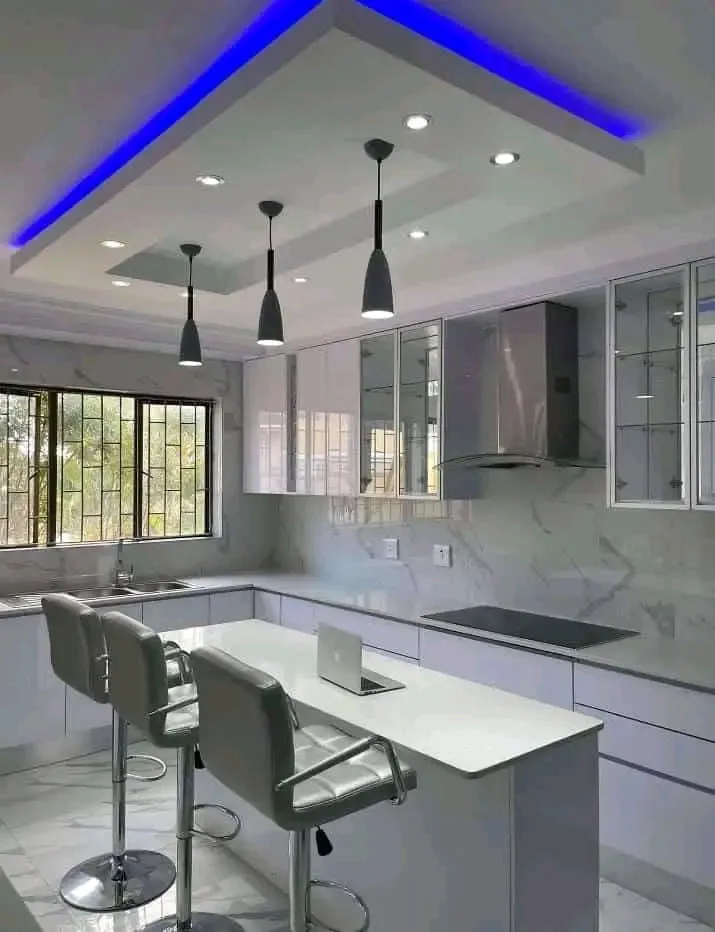 Modern kitchen with LED downlights and blue ambient strip lighting installed by Danford Electrical, Sandton